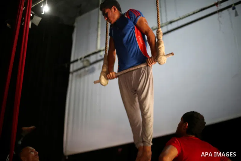 One of the Irish trainer Jennifer Higgins's students from Gaza circus to performs during an aerial silks practice class in Gaza City, on August 3, 2017. Photo by Mohammed Asad