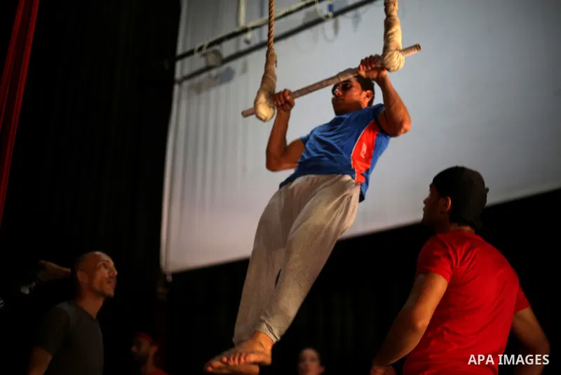 One of the Irish trainer Jennifer Higgins's students from Gaza circus to performs during an aerial silks practice class in Gaza City, on August 3, 2017. Photo by Mohammed Asad