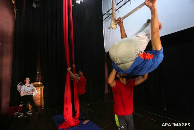 One of the Irish trainer Jennifer Higgins's students from Gaza circus to performs during an aerial silks practice class in Gaza City, on August 3, 2017. Photo by Mohammed Asad