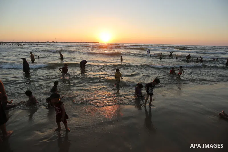 Palestinians enjoy their time at the beach of the Mediterranean sea on the coast of Gaza city on August 4, 2017. Photo by Ashraf Amra