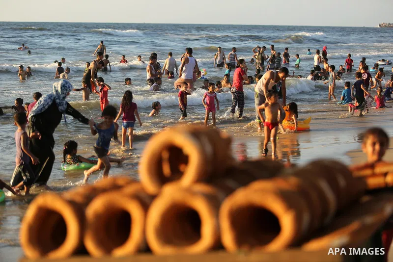 Palestinians enjoy their time at the beach of the Mediterranean sea on the coast of Gaza city on August 4, 2017. Photo by Ashraf Amra