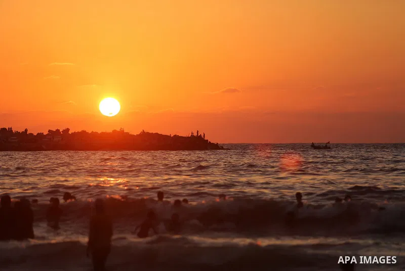 Palestinians enjoy their time at the beach of the Mediterranean sea on the coast of Gaza city on August 4, 2017. Photo by Ashraf Amra