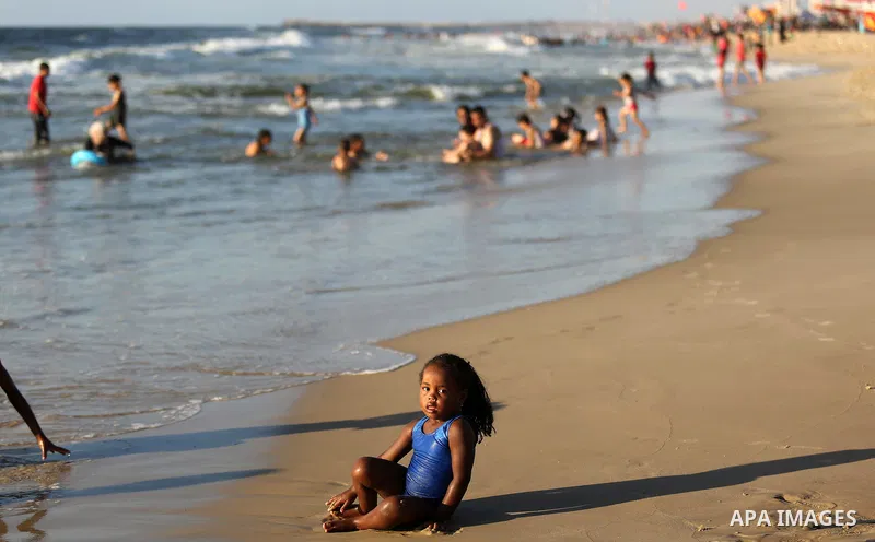 Palestinians enjoy their time at the beach of the Mediterranean sea on the coast of Gaza city on August 4, 2017. Photo by Ashraf Amra