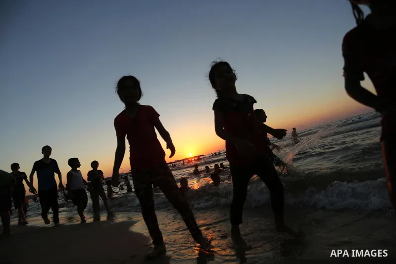 Palestinians enjoy their time at the beach of the Mediterranean sea on the coast of Gaza city on August 4, 2017. Photo by Ashraf Amra