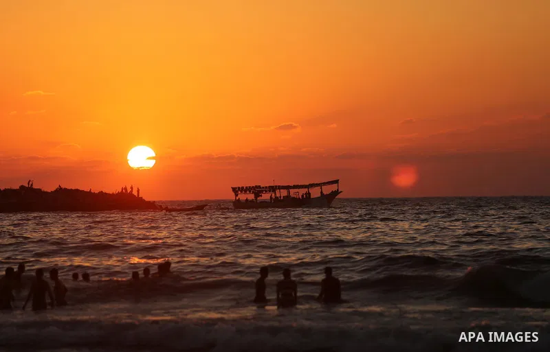 Palestinians enjoy their time at the beach of the Mediterranean sea on the coast of Gaza city on August 4, 2017. Photo by Ashraf Amra