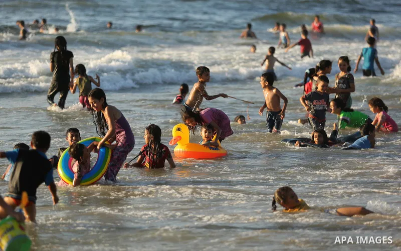 Palestinians enjoy their time at the beach of the Mediterranean sea on the coast of Gaza city on August 4, 2017. Photo by Ashraf Amra