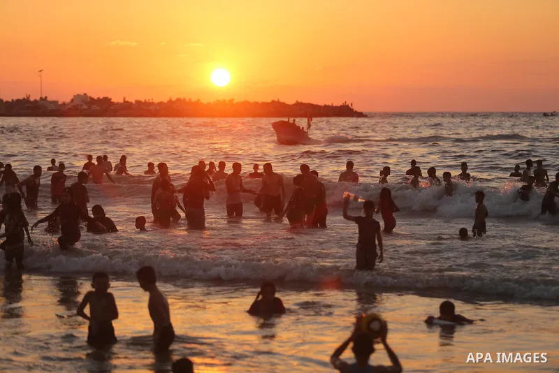 Palestinians enjoy their time at the beach of the Mediterranean sea on the coast of Gaza city on August 4, 2017. Photo by Ashraf Amra
