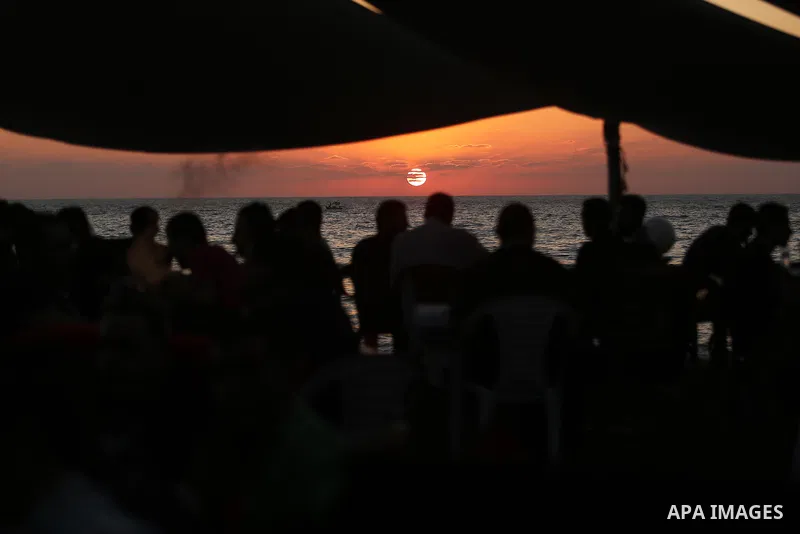 Palestinians enjoy their time at the beach of the Mediterranean sea on the coast of Gaza city on August 4, 2017. Photo by Ashraf Amra