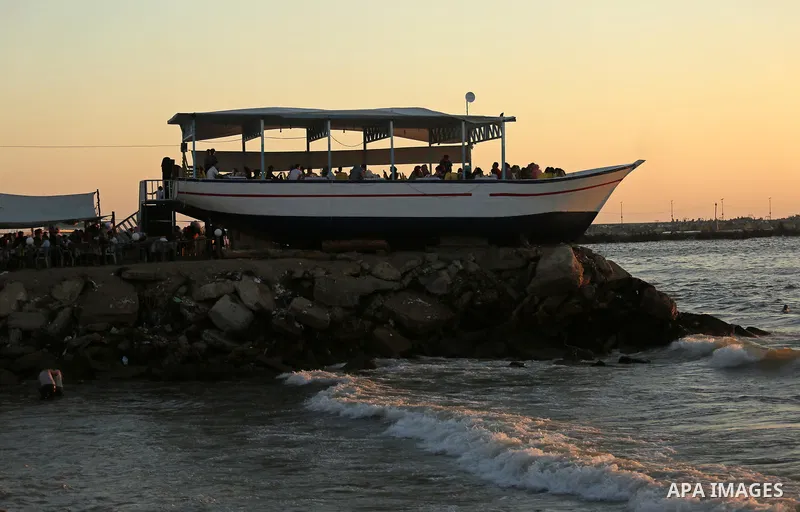 Palestinians are seen aboard "Lolo Rose" ship which has become a popular restaurant, on a beach in Gaza City on August 4, 2017. Photo by Ashraf Amra