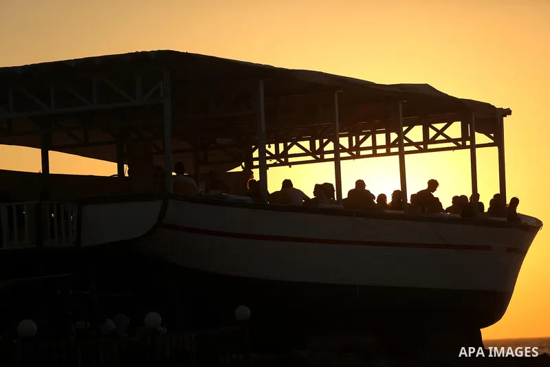 Palestinians are seen aboard "Lolo Rose" ship which has become a popular restaurant, on a beach in Gaza City on August 4, 2017. Photo by Ashraf Amra