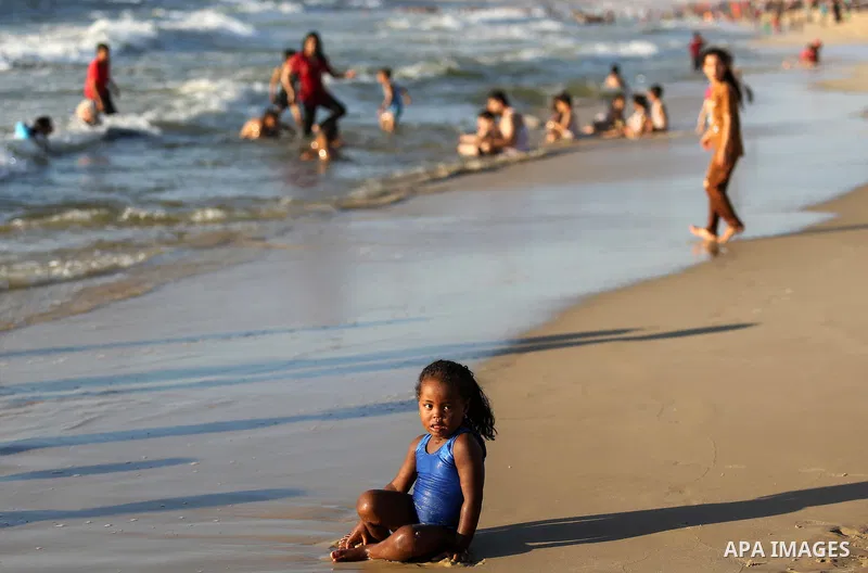 Palestinians enjoy their time at the beach of the Mediterranean sea on the coast of Gaza city on August 4, 2017. Photo by Ashraf Amra
