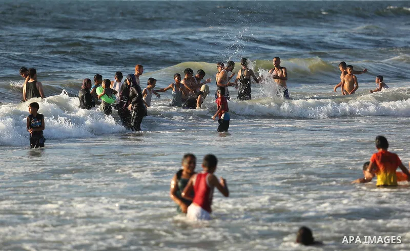 Palestinians enjoy their time at the beach of the Mediterranean sea on the coast of Gaza city on August 4, 2017. Photo by Ashraf Amra
