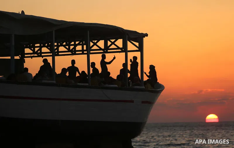 Palestinians are seen aboard "Lolo Rose" ship which has become a popular restaurant, on a beach in Gaza City on August 4, 2017. Photo by Ashraf Amra