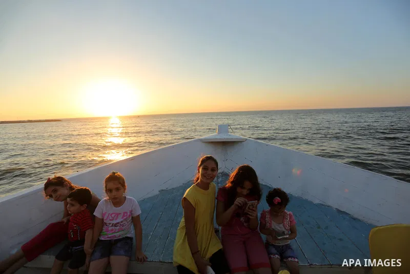Palestinians are seen aboard "Lolo Rose" ship which has become a popular restaurant, on a beach in Gaza City on August 4, 2017. Photo by Ashraf Amra