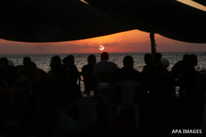 Palestinians enjoy their time at the beach of the Mediterranean sea on the coast of Gaza city on August 4, 2017. Photo by Ashraf Amra