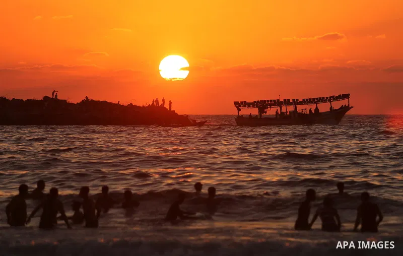 Palestinians enjoy their time at the beach of the Mediterranean sea on the coast of Gaza city on August 4, 2017. Photo by Ashraf Amra