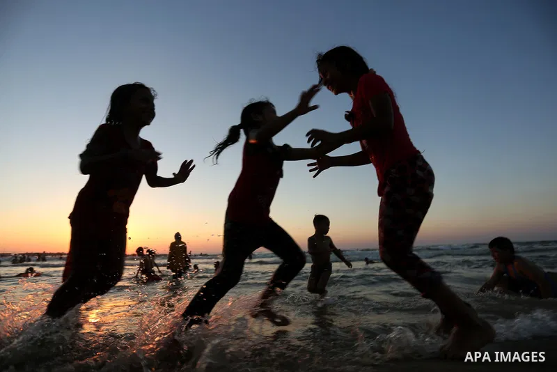 Palestinians enjoy their time at the beach of the Mediterranean sea on the coast of Gaza city on August 4, 2017. Photo by Ashraf Amra