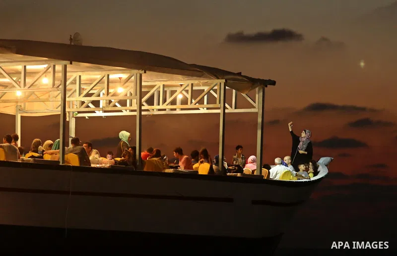 Palestinians are seen aboard "Lolo Rose" ship which has become a popular restaurant, on a beach in Gaza City on August 4, 2017. Photo by Ashraf Amra