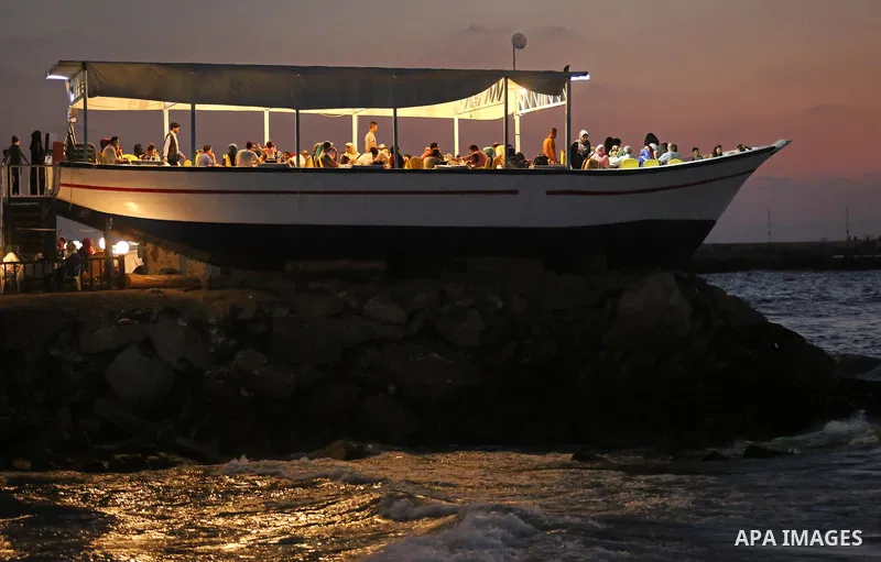 Palestinians are seen aboard "Lolo Rose" ship which has become a popular restaurant, on a beach in Gaza City on August 4, 2017. Photo by Ashraf Amra