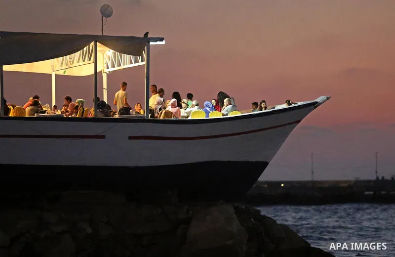 Palestinians are seen aboard "Lolo Rose" ship which has become a popular restaurant, on a beach in Gaza City on August 4, 2017. Photo by Ashraf Amra