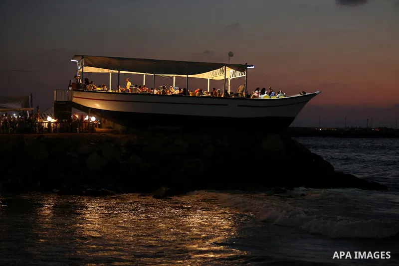 Palestinians are seen aboard "Lolo Rose" ship which has become a popular restaurant, on a beach in Gaza City on August 4, 2017. Photo by Ashraf Amra