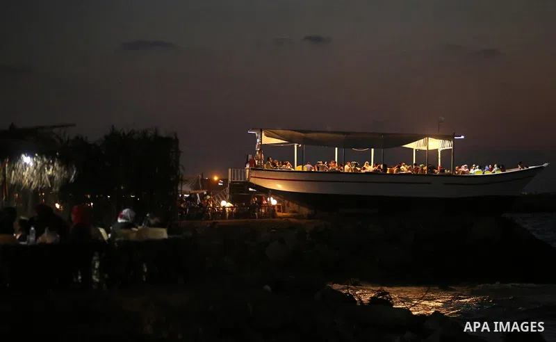 Palestinians are seen aboard "Lolo Rose" ship which has become a popular restaurant, on a beach in Gaza City on August 4, 2017. Photo by Ashraf Amra