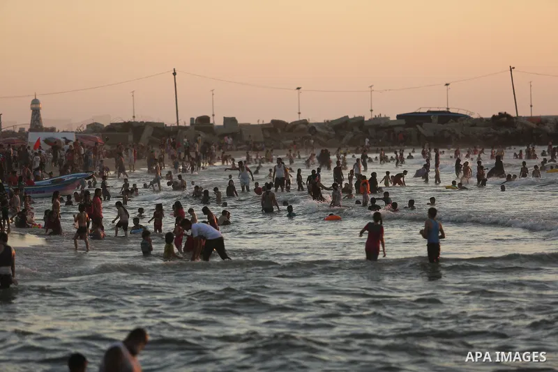 Palestinians enjoy their time at the beach of the Mediterranean sea on the coast of Gaza city on August 4, 2017. Photo by Ashraf Amra
