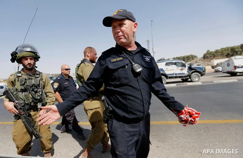 Israeli forensic policemen inspect the place where a 24-year-old Palestinian attempted to stab Israeli soldiers and was shot dead by security forces, at the Gush Etzion junction, a settlement bloc next to the biblical Pa...