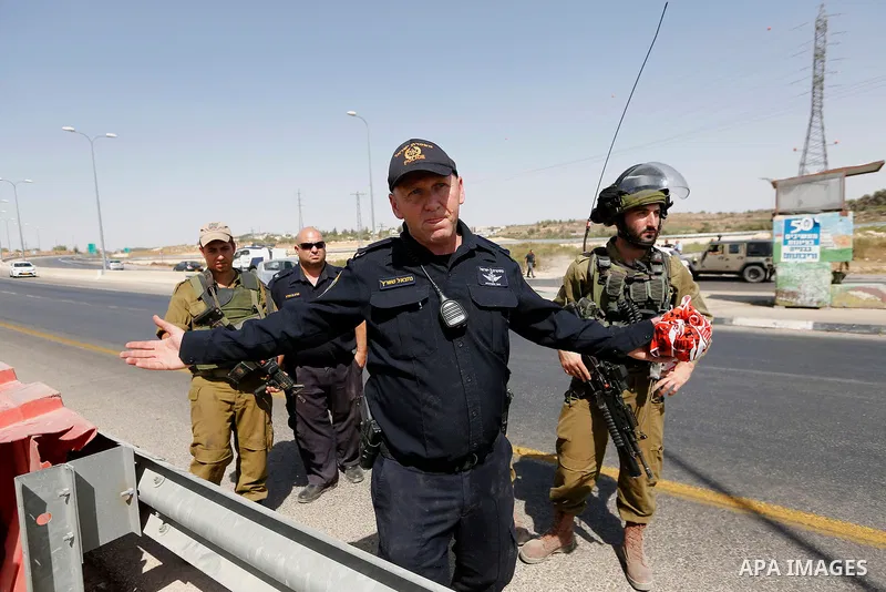 Israeli forensic policemen inspect the place where a 24-year-old Palestinian attempted to stab Israeli soldiers and was shot dead by security forces, at the Gush Etzion junction, a settlement bloc next to the biblical Pa...