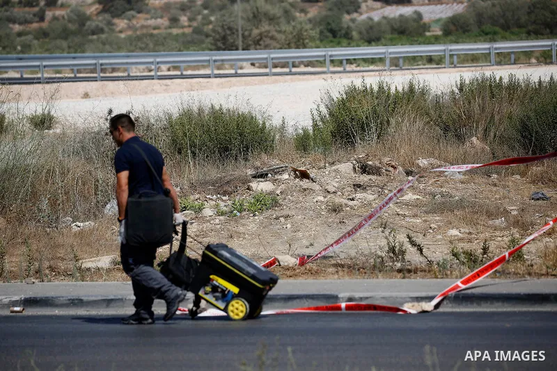 Israeli forensic policemen inspect the place where a 24-year-old Palestinian attempted to stab Israeli soldiers and was shot dead by security forces, at the Gush Etzion junction, a settlement bloc next to the biblical Pa...