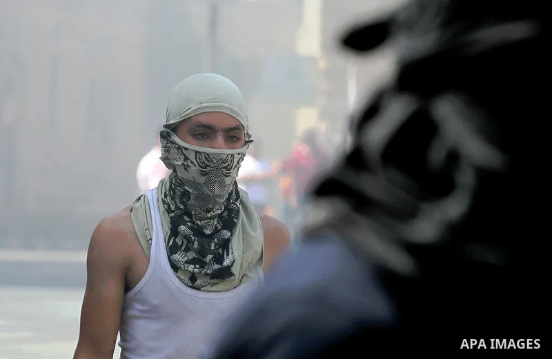 Palestinian protesters hurl stones during clashes between demonstrators and Israeli security forces in the city of Hebron in the Israeli-occupied West Bank, on July 28, 2017, as protests erupt in support of the Al-Aqsa m...