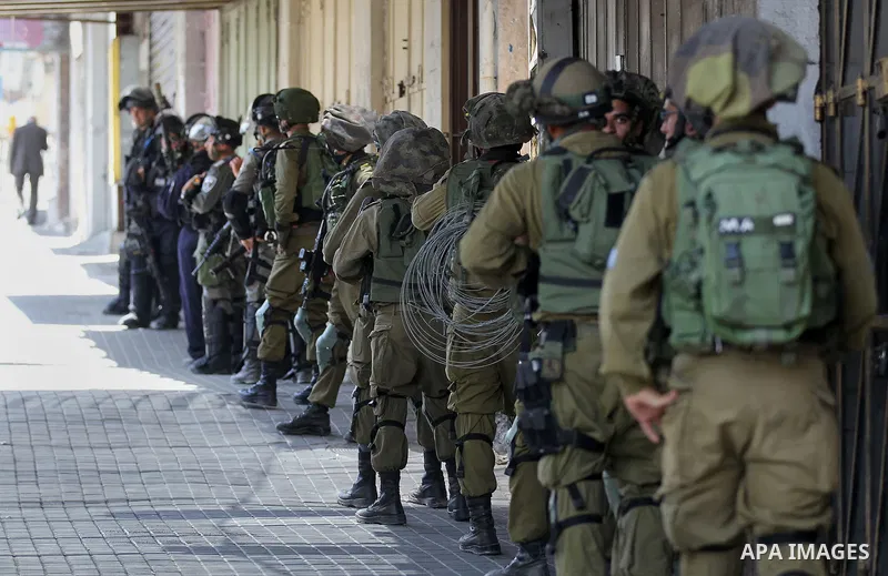Israeli forces fire towards Palestinian demonstrators during clashes in the city of Hebron in the Israeli-occupied West Bank, on July 28, 2017, as protests erupt in support of the Al-Aqsa mosque compound after Israeli po...