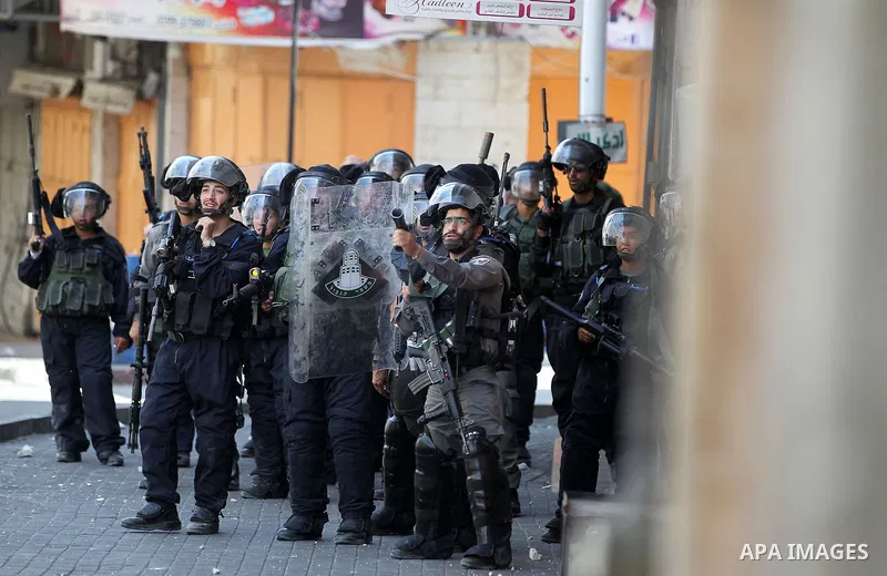 Israeli forces fire towards Palestinian demonstrators during clashes in the city of Hebron in the Israeli-occupied West Bank, on July 28, 2017, as protests erupt in support of the Al-Aqsa mosque compound after Israeli po...
