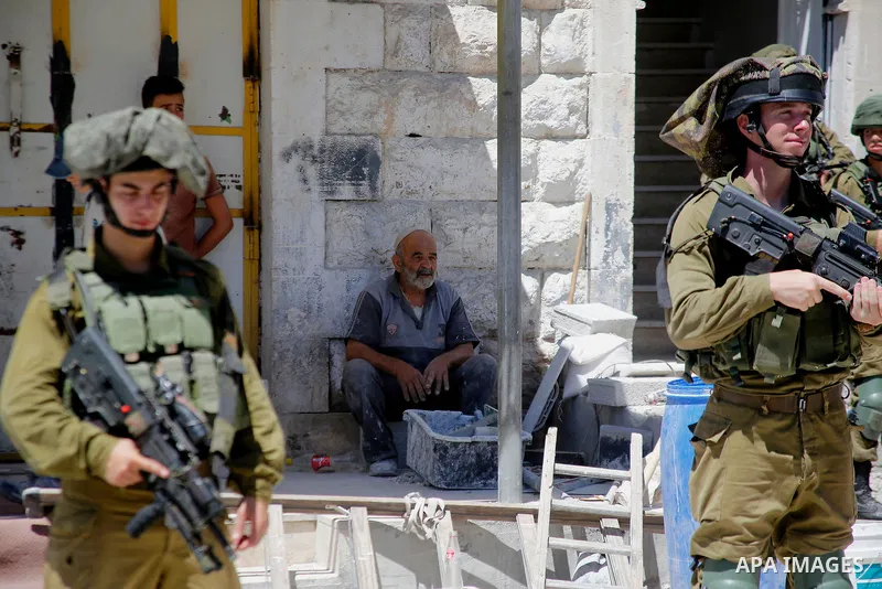 Israeli security forces confiscate files and cam recorders during a raid on the Palestinians committee of security in H2 area in the West bank city of Hebron on August 2, 2017. The H2 area is inhabited by approximately 3...