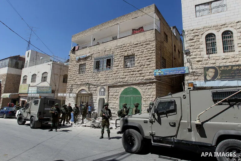 Israeli security forces confiscate files and cam recorders during a raid on the Palestinians committee of security in H2 area in the West bank city of Hebron on August 2, 2017. The H2 area is inhabited by approximately 3...