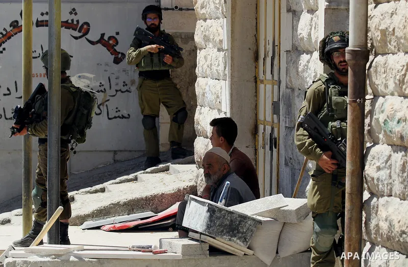 Israeli security forces confiscate files and cam recorders during a raid on the Palestinians committee of security in H2 area in the West bank city of Hebron on August 2, 2017. The H2 area is inhabited by approximately 3...