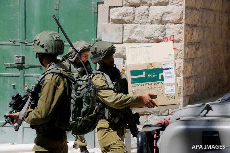 Israeli security forces confiscate files and cam recorders during a raid on the Palestinians committee of security in H2 area in the West bank city of Hebron on August 2, 2017. The H2 area is inhabited by approximately 3...