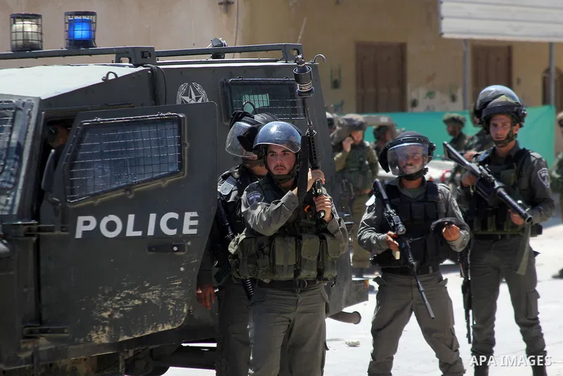 Israeli army soldiers take position during a protest against building a new Israeli military tower in the West Bank town of Dura, south of Hebron August 4, 2017. Photo by Wisam Hashlamoun