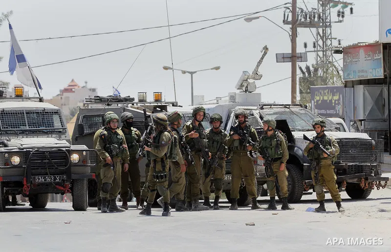 Israeli army soldiers take position during a protest against building a new Israeli military tower in the West Bank town of Dura, south of Hebron August 4, 2017. Photo by Wisam Hashlamoun