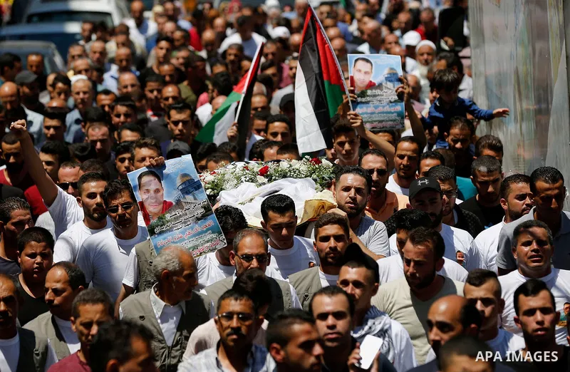 Palestinians carry the body of Palestinian Rafat Herbawi who had been killed in July 19 by Israeli soldiers after allegedly attempting car- ramming attack during his funeral in the West Bank of Hebron, on August 5, 2017....