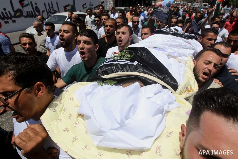 Palestinians carry the body of Palestinian Rafat Herbawi who had been killed in July 19 by Israeli soldiers after allegedly attempting car- ramming attack during his funeral in the West Bank of Hebron, on August 5, 2017....