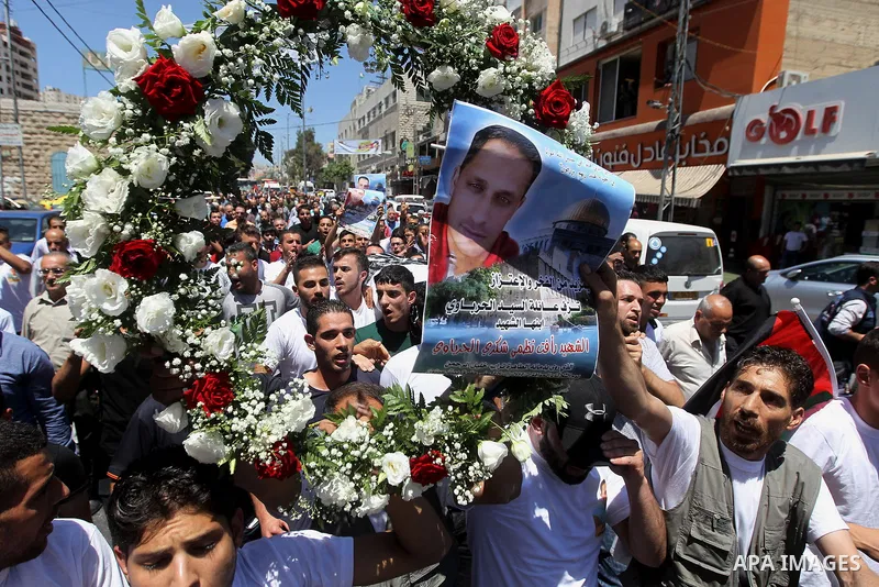 Palestinians carry the body of Palestinian Rafat Herbawi who had been killed in July 19 by Israeli soldiers after allegedly attempting car- ramming attack during his funeral in the West Bank of Hebron, on August 5, 2017....
