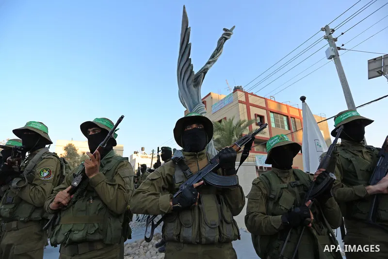 Members of the Ezzedine al-Qassam Brigades, the military wing of the Palestinian Islamist movement Hamas take part during the opening ceremony of Mazen Faqha square, in Nusseirat refugee camp, in the central Gaza Strip,...