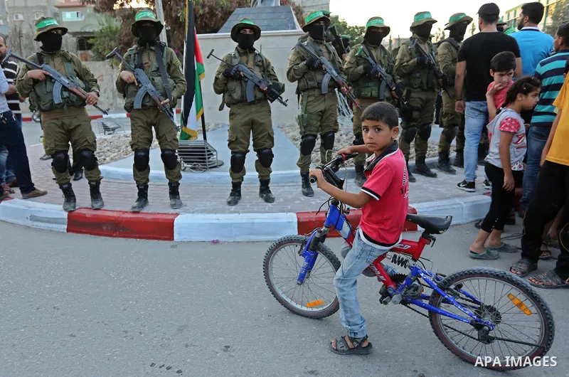 Members of the Ezzedine al-Qassam Brigades, the military wing of the Palestinian Islamist movement Hamas take part during the opening ceremony of Mazen Faqha square, in Nusseirat refugee camp, in the central Gaza Strip,...