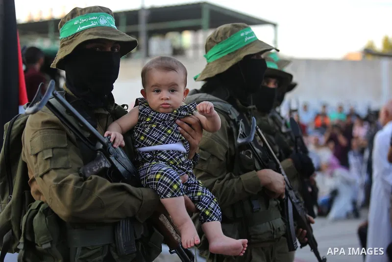 Members of the Ezzedine al-Qassam Brigades, the military wing of the Palestinian Islamist movement Hamas take part during the opening ceremony of Mazen Faqha square, in Nusseirat refugee camp, in the central Gaza Strip,...