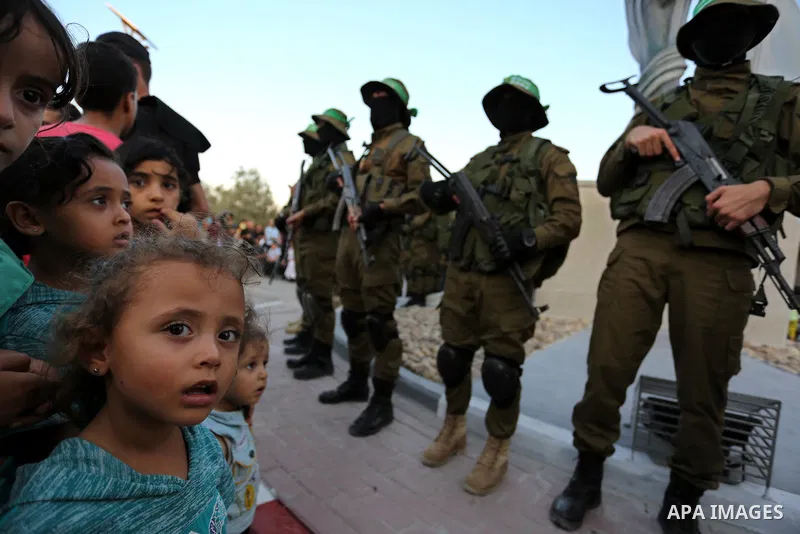 Members of the Ezzedine al-Qassam Brigades, the military wing of the Palestinian Islamist movement Hamas take part during the opening ceremony of Mazen Faqha square, in Nusseirat refugee camp, in the central Gaza Strip,...