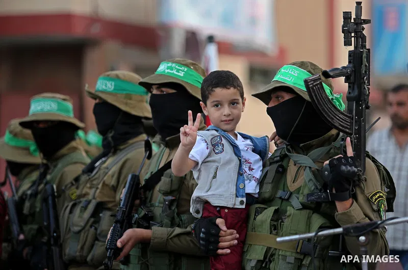 Members of the Ezzedine al-Qassam Brigades, the military wing of the Palestinian Islamist movement Hamas take part during the opening ceremony of Mazen Faqha square, in Nusseir at refugee camp, in the central Gaza Strip,...