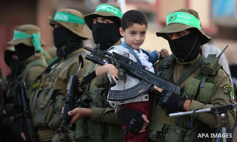 Members of the Ezzedine al-Qassam Brigades, the military wing of the Palestinian Islamist movement Hamas take part during the opening ceremony of Mazen Faqha square, in Nusseir at refugee camp, in the central Gaza Strip,...