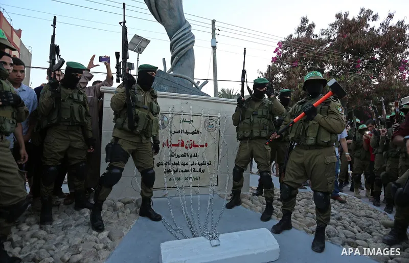 Members of the Ezzedine al-Qassam Brigades, the military wing of the Palestinian Islamist movement Hamas take part during the opening ceremony of Mazen Faqha square, in Nusseir at refugee camp, in the central Gaza Strip,...