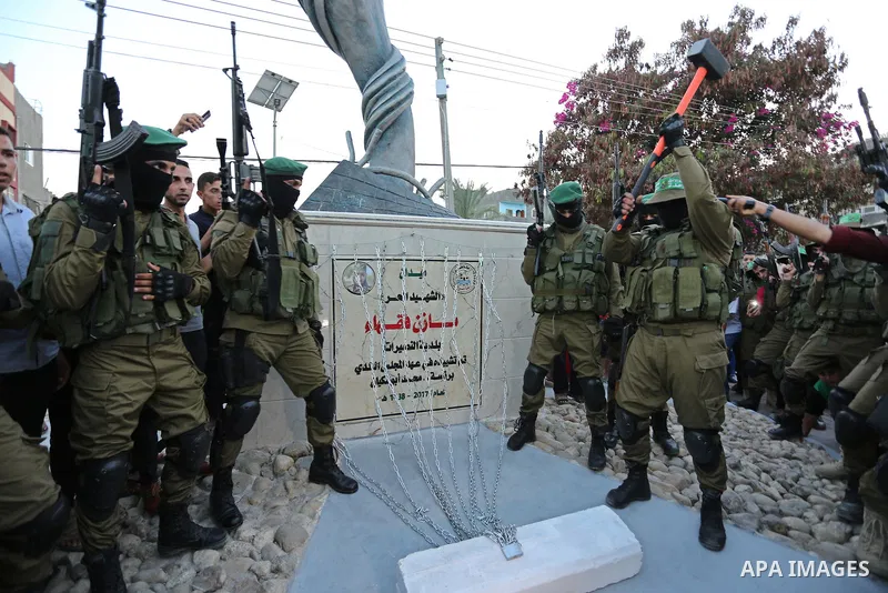 Members of the Ezzedine al-Qassam Brigades, the military wing of the Palestinian Islamist movement Hamas take part during the opening ceremony of Mazen Faqha square, in Nusseir at refugee camp, in the central Gaza Strip,...